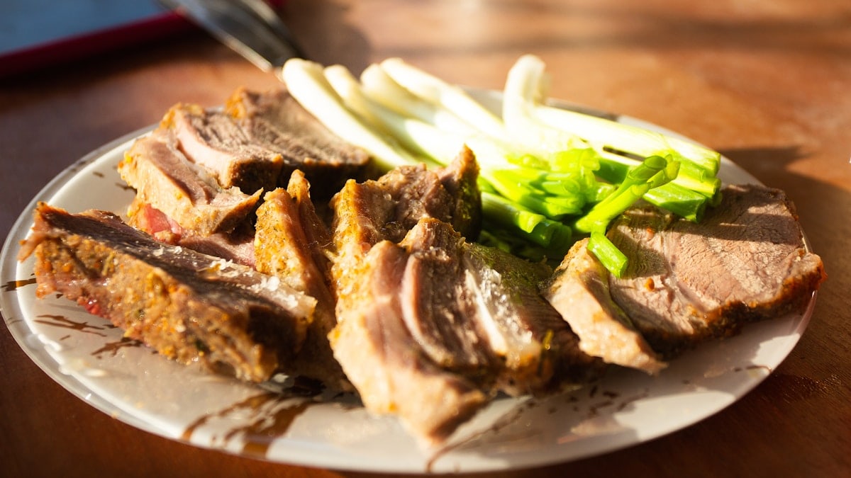 a white plate topped with meat and veggies